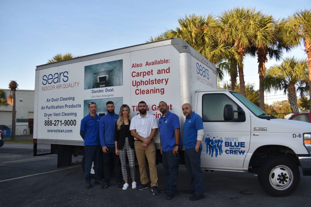 Sears of Tampa Team standing in front of a utility van.