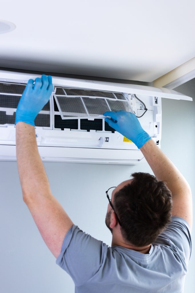 Technician Performing Routine Maintenance on HVAC